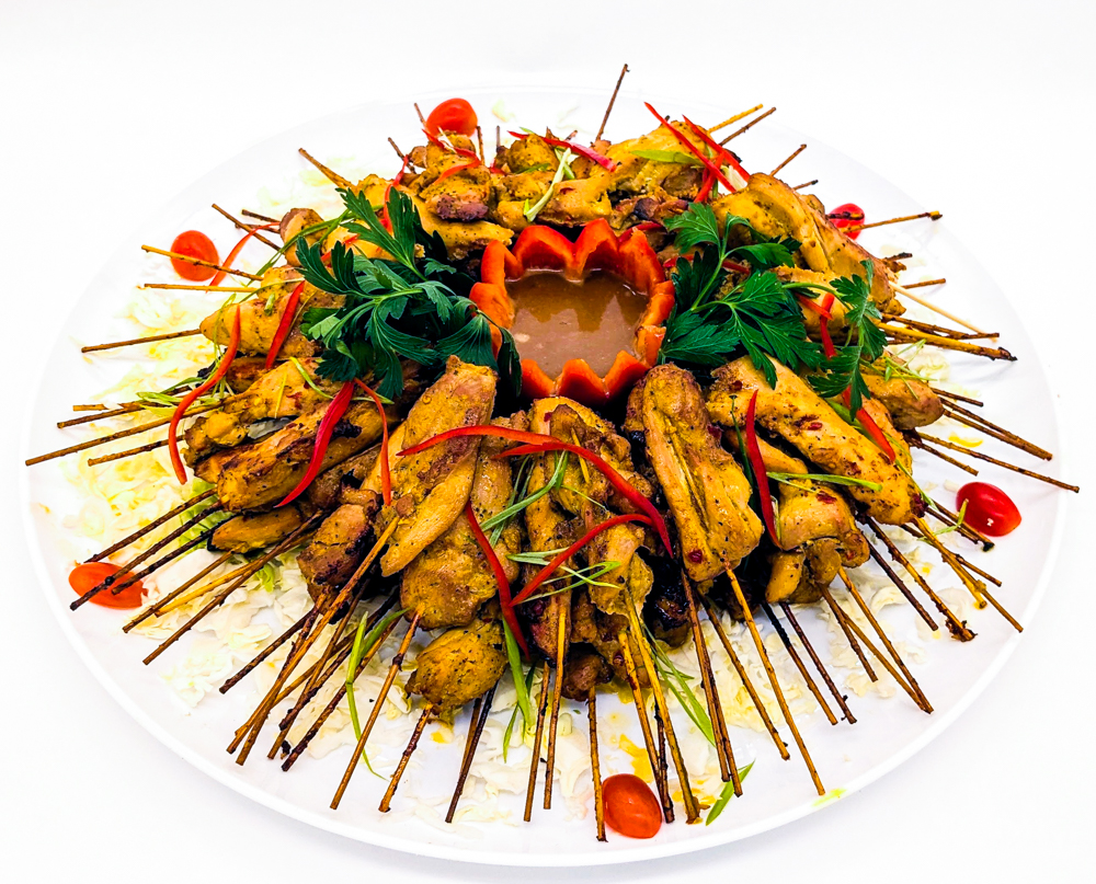 Malaysian Chicken satays platter with a coconut peanut dip