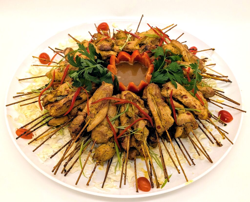 Malaysian Chicken Satays platter with a coconut peanut sauce