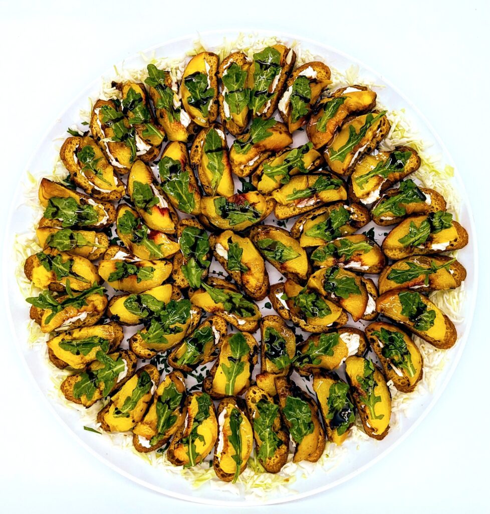 Grilled peach crostini platter with ricotta, grilled peach, arugula, honey and a balsamic drizzle