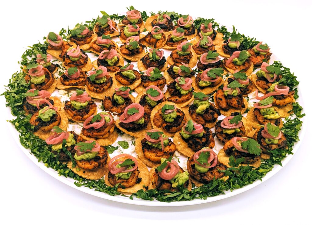 Shrimp tostadas platter with guacamole and pickled onion